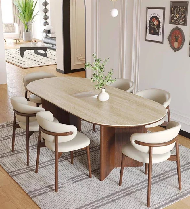 Sculptural oak dining table, upholstered chairs and carefully curated art in a light-filled interior